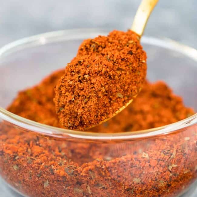 homemade chili seasoning being scooped up with a spoon