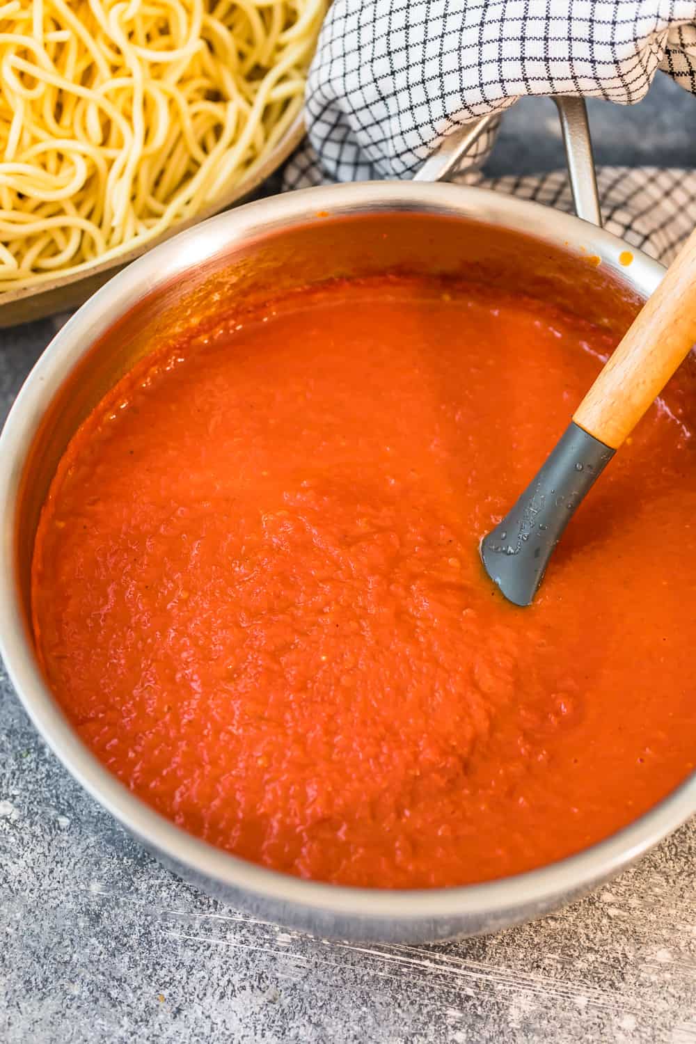 stirring homemade marinara sauce