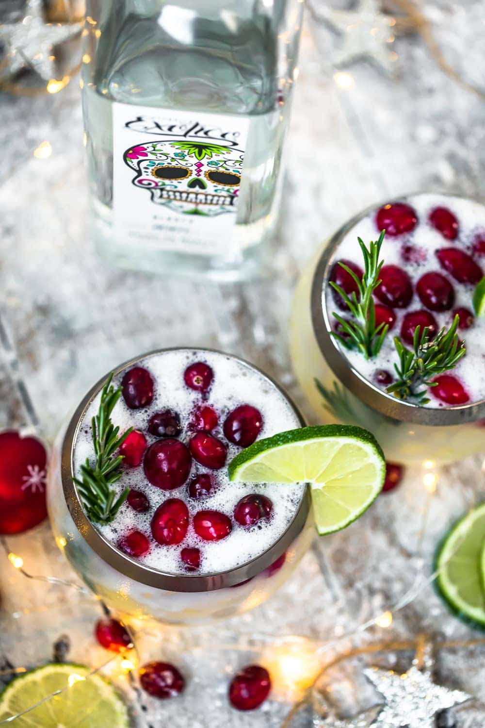 christmas cocktail topped with rosemary and cranberries