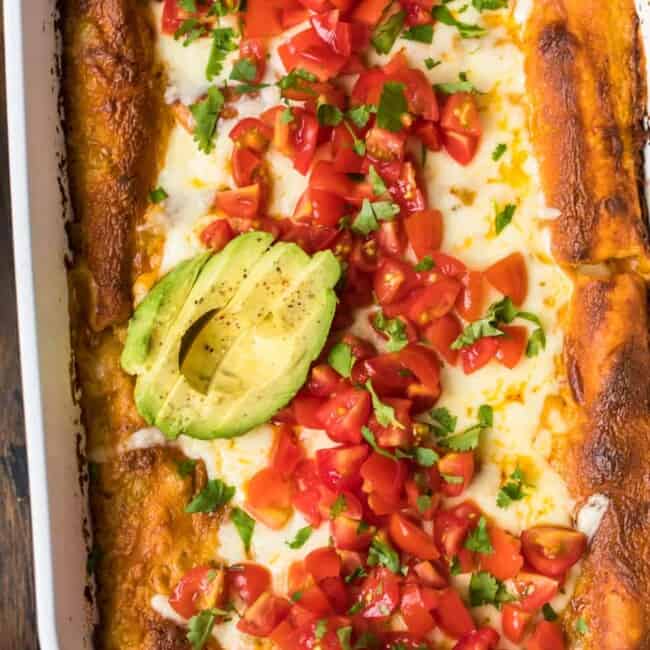 chicken enchiladas topped with avocado