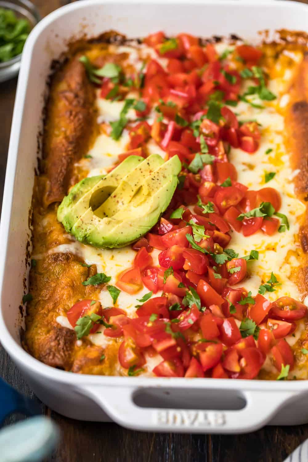 avocado on top of creamy chicken enchiladas