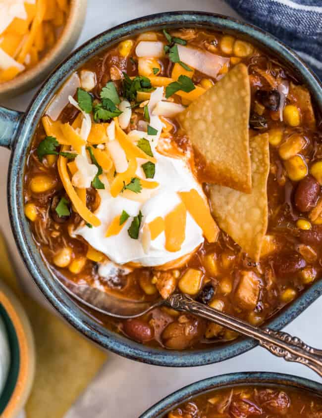 chicken taco soup in a bowl with chips and sour cream garnish