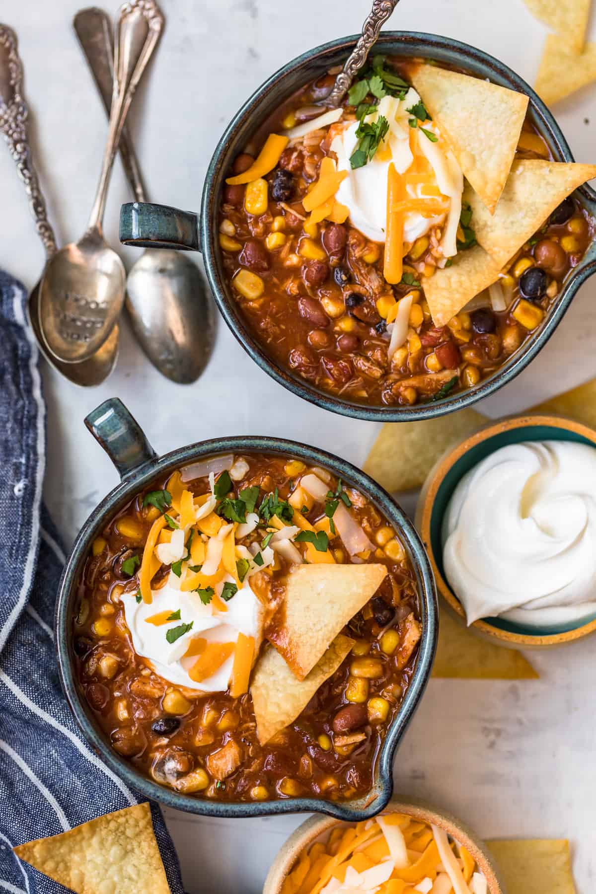 Two bowls of soup with spoons