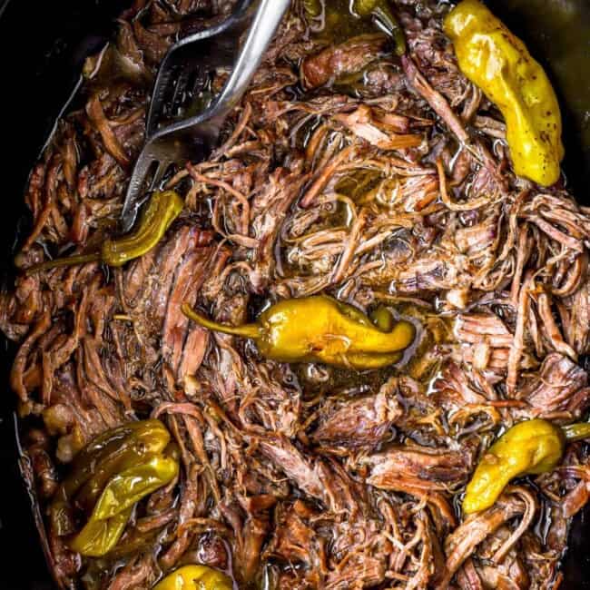 A slow cooker filled with Mississippi pot roast.