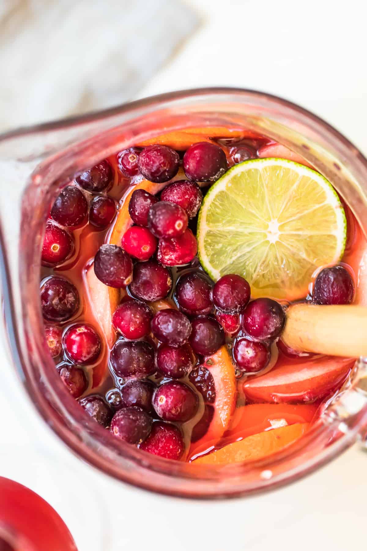 The non alcoholic sangria in a pitcher with fruits