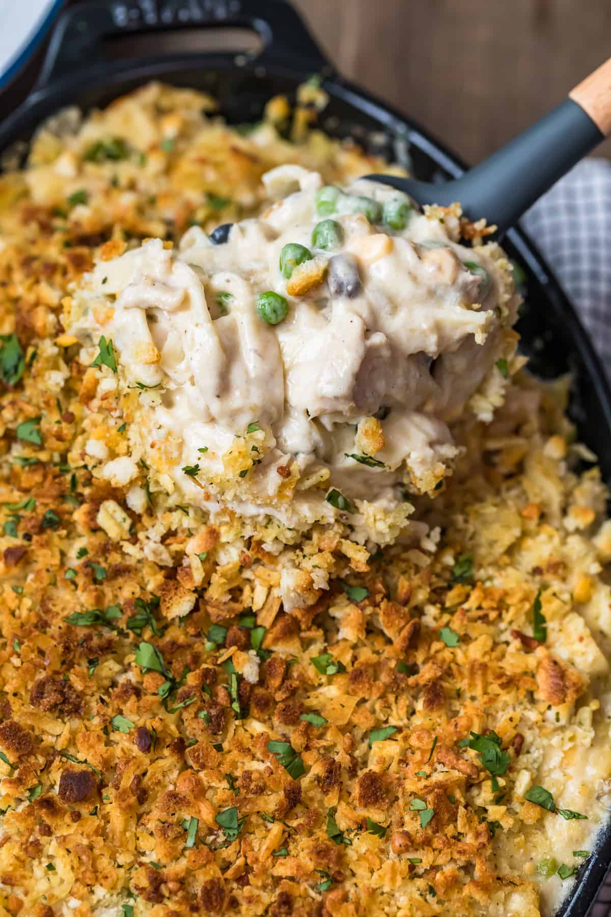 Tuna Noodle Casserole being lifted out of the dish with a spoon