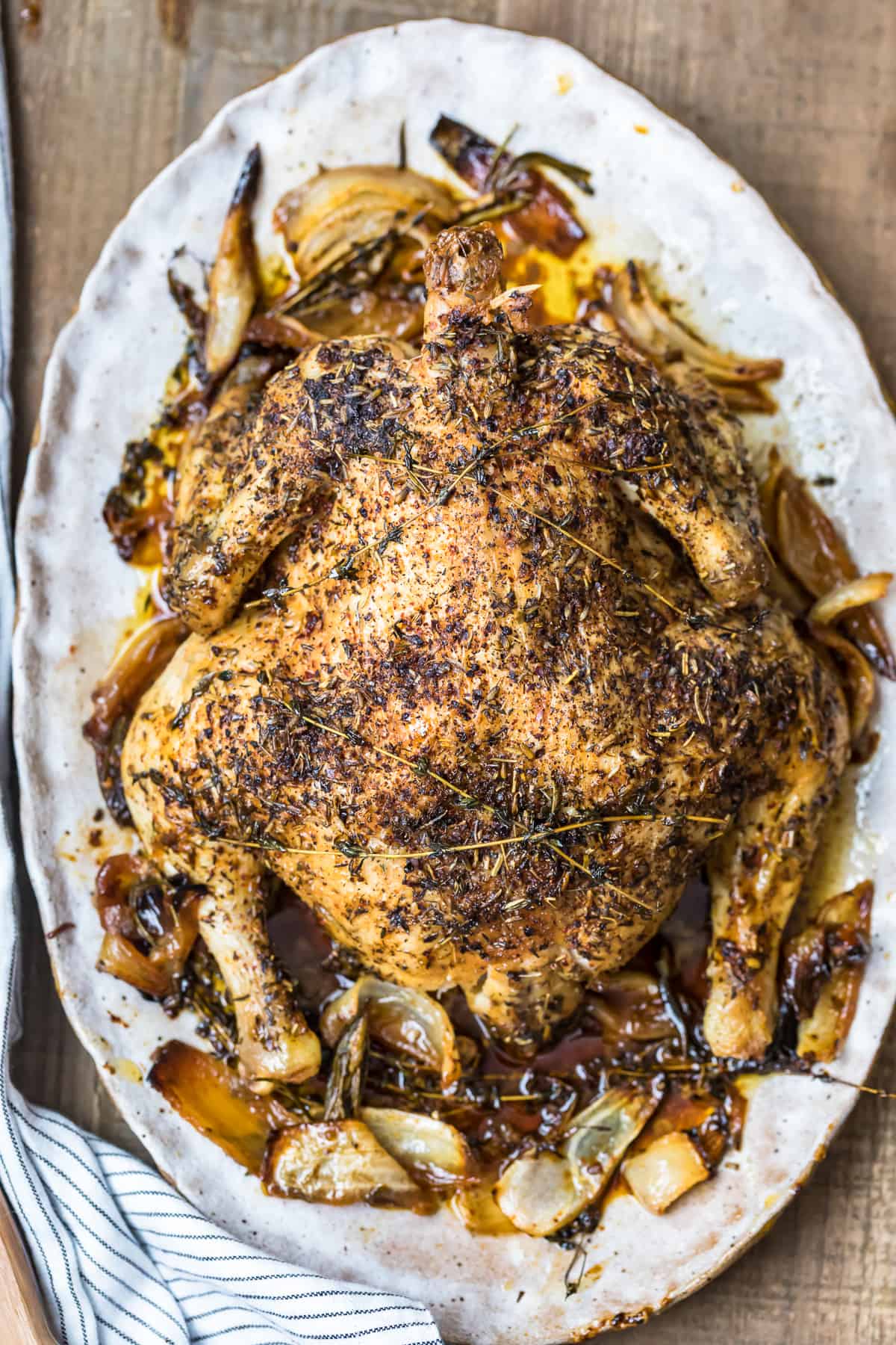 whole roast chicken served on a white plate