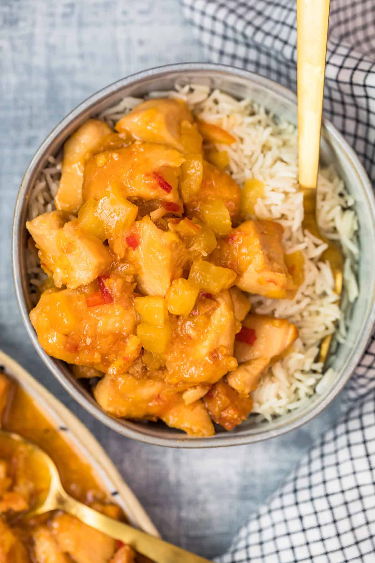 over the top view of sweet and sour chicken and a bowl of rice