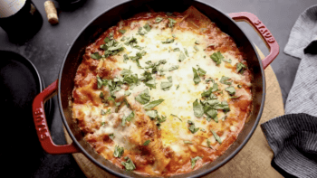 dutch oven lasagna topped with basil.