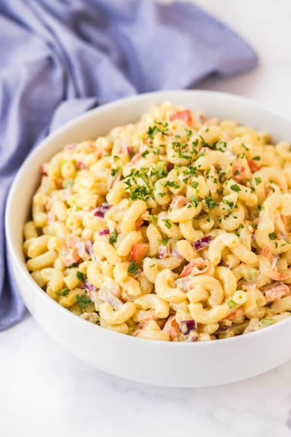 side image of macaroni salad in white bowl