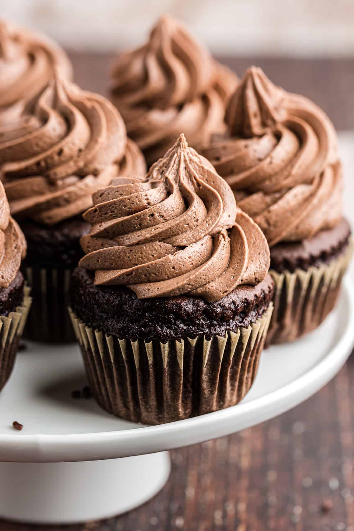 cake stand filled with chocolate cupcakes