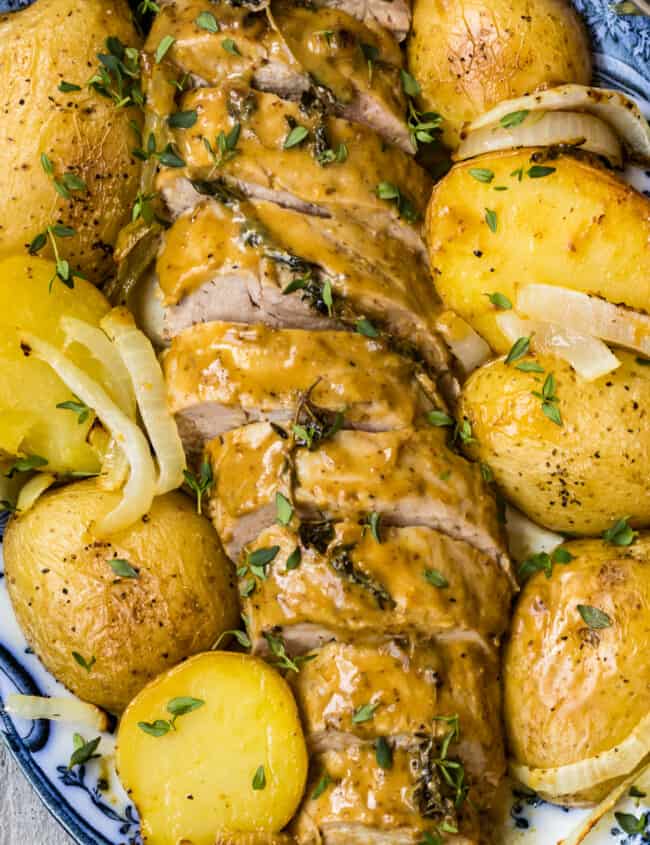 up close image of honey mustard pork tenderloin with potatoes on platter