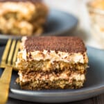 slice of tiramisu on black plate