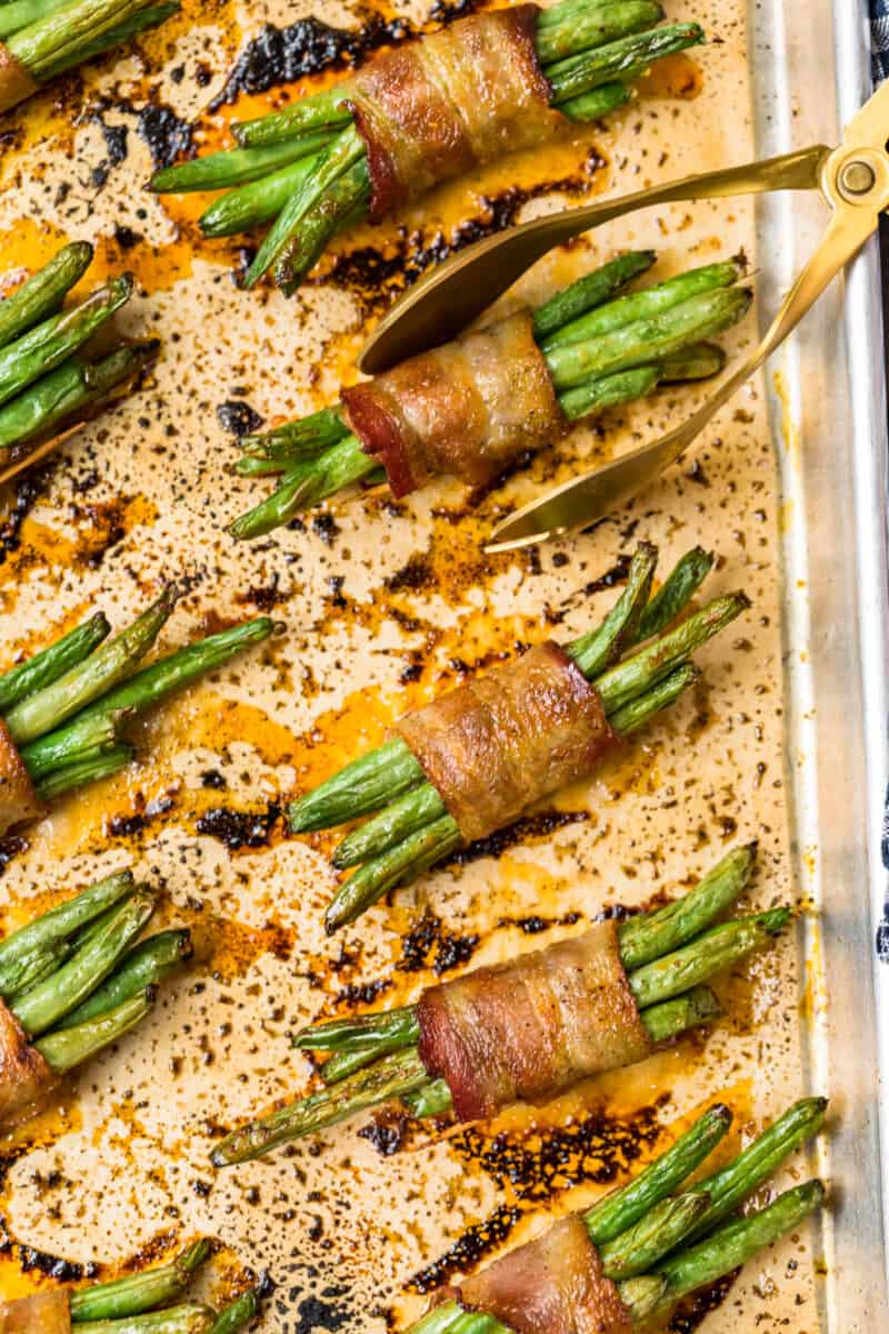 bacon wrapped green bean bundles on baking sheet