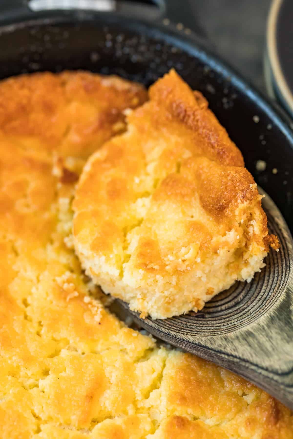 lifting up spoonful of buttermilk spoon bread