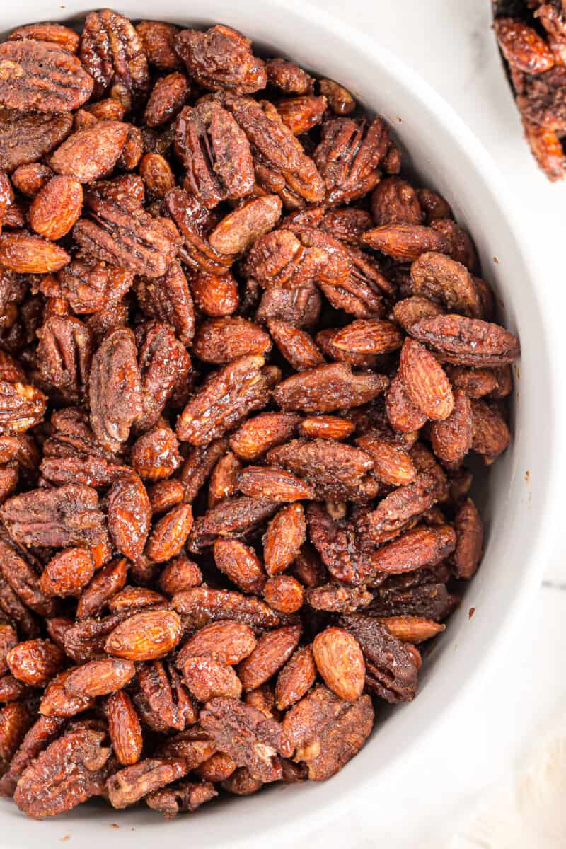 white bowl of candied nuts made in slow cooker