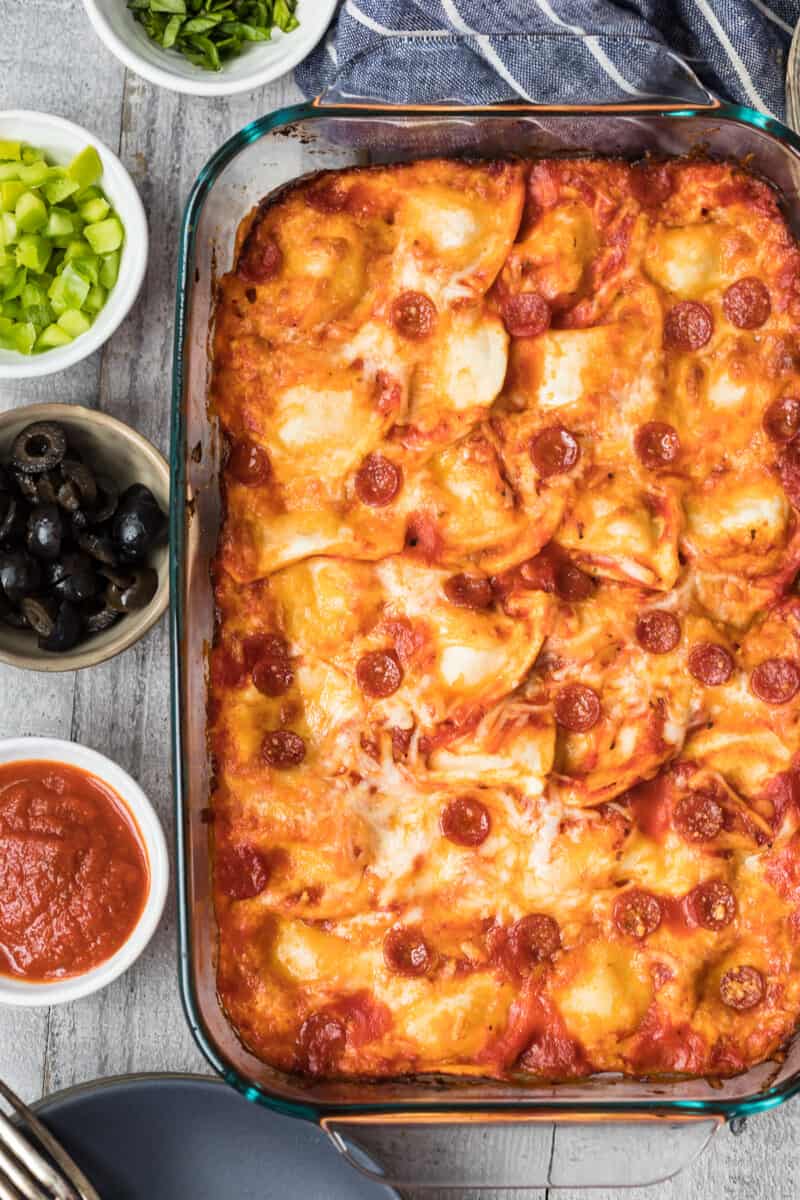 pierogy pizza casserole in baking dish next to toppings