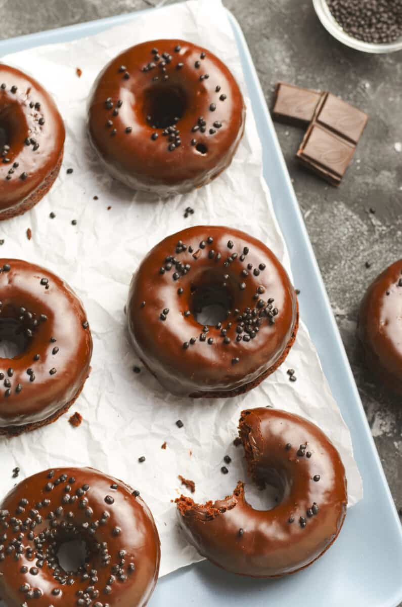 chocolate donuts on platter with parchment