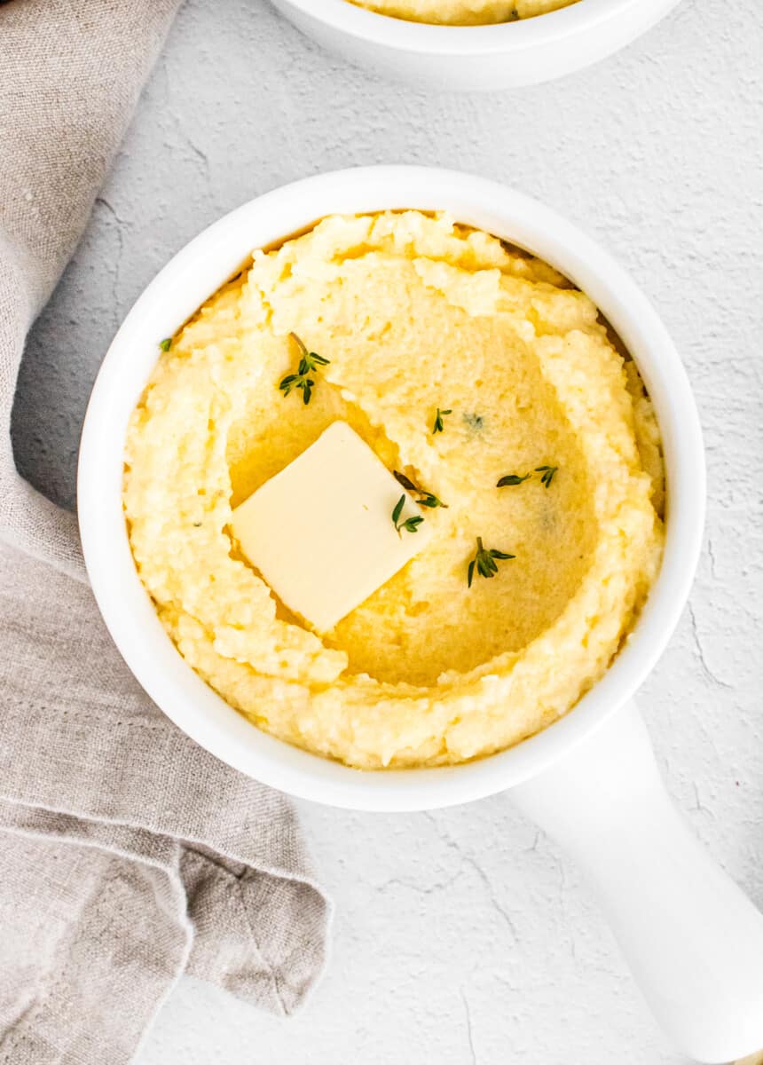 parmesan polenta in white dish with butter