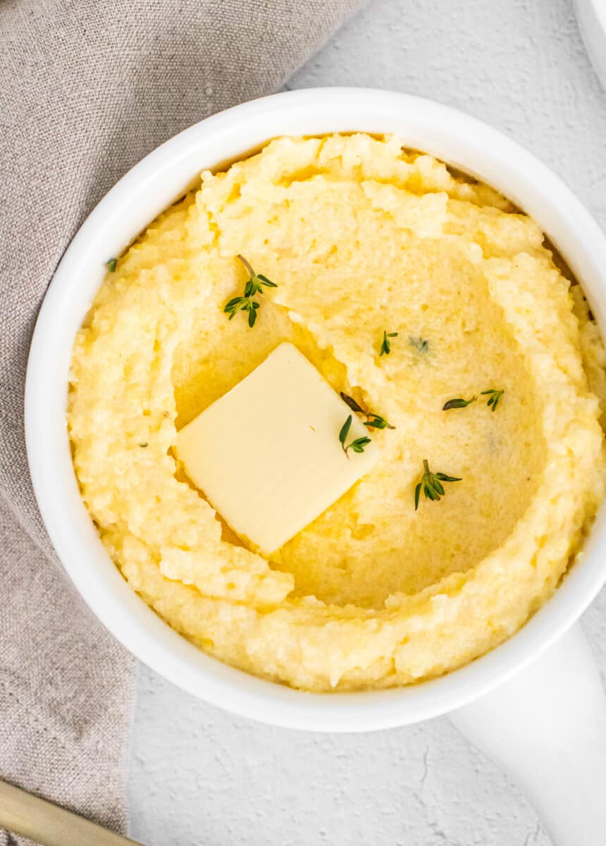 parmesan polenta in white dish with butter