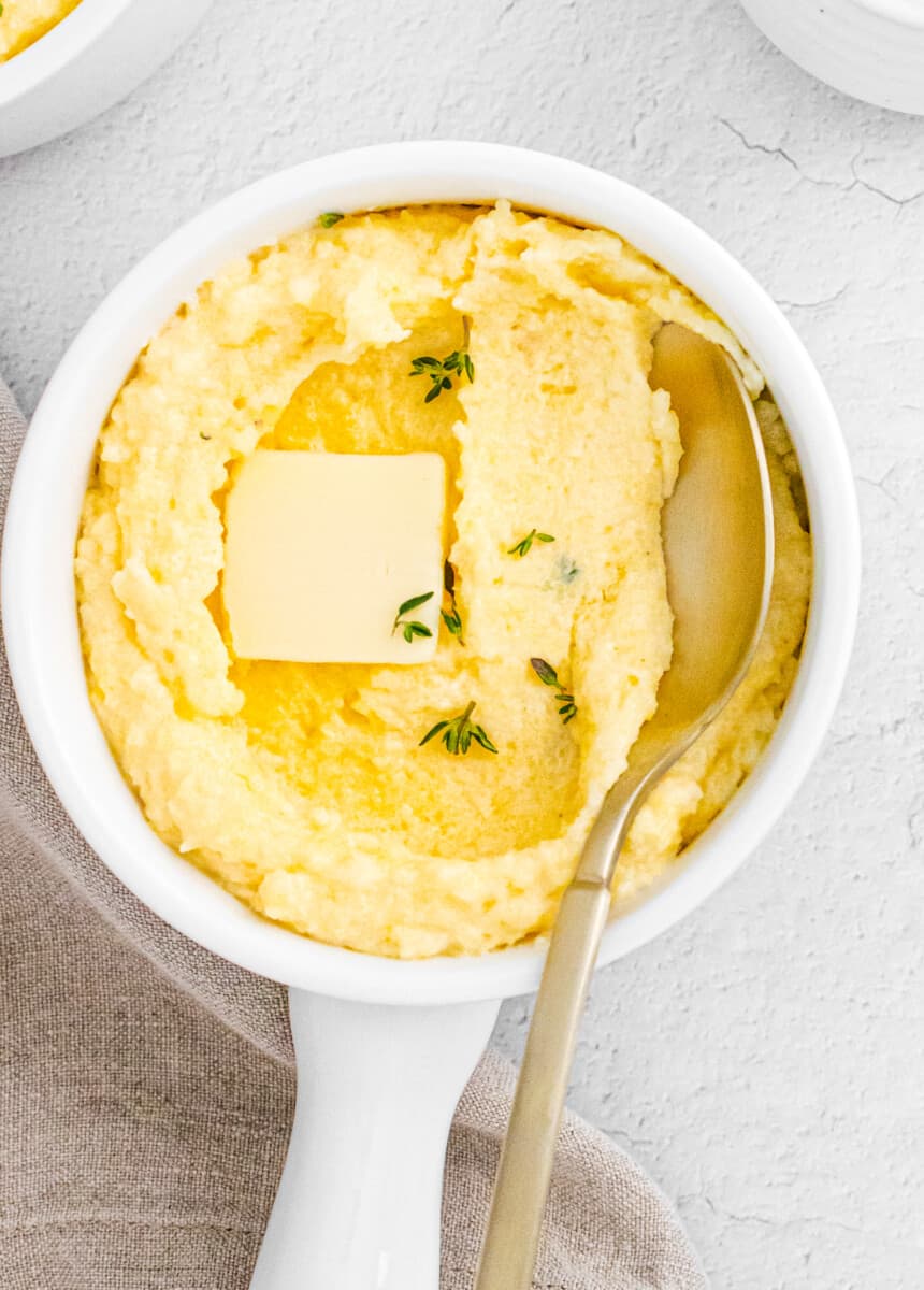 spoon digging into parmesan poletna