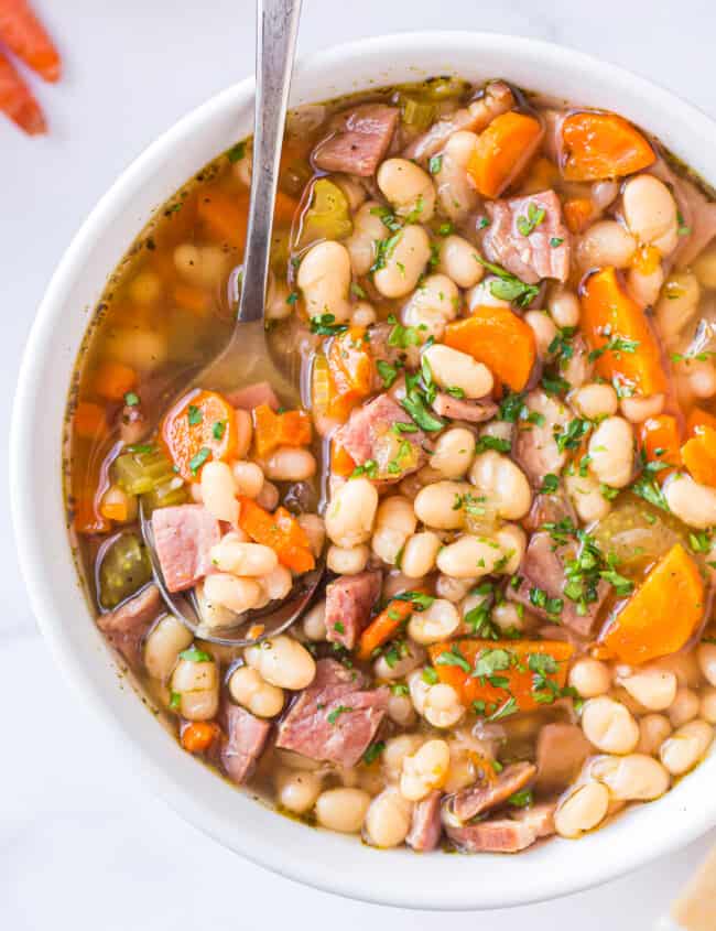 spoon in bowl of instant pot ham and bean soup