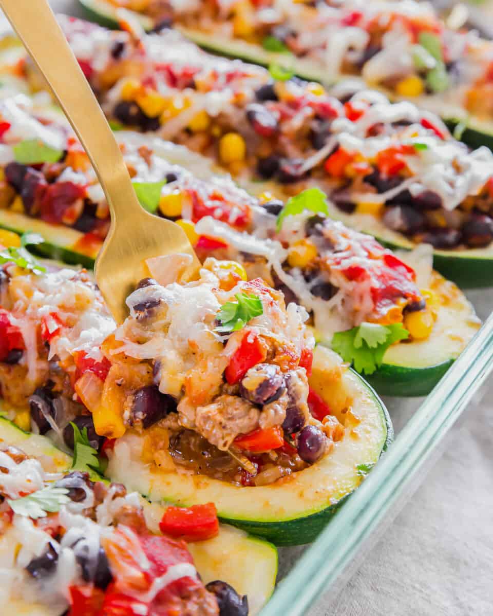 fork digging into zucchini boat