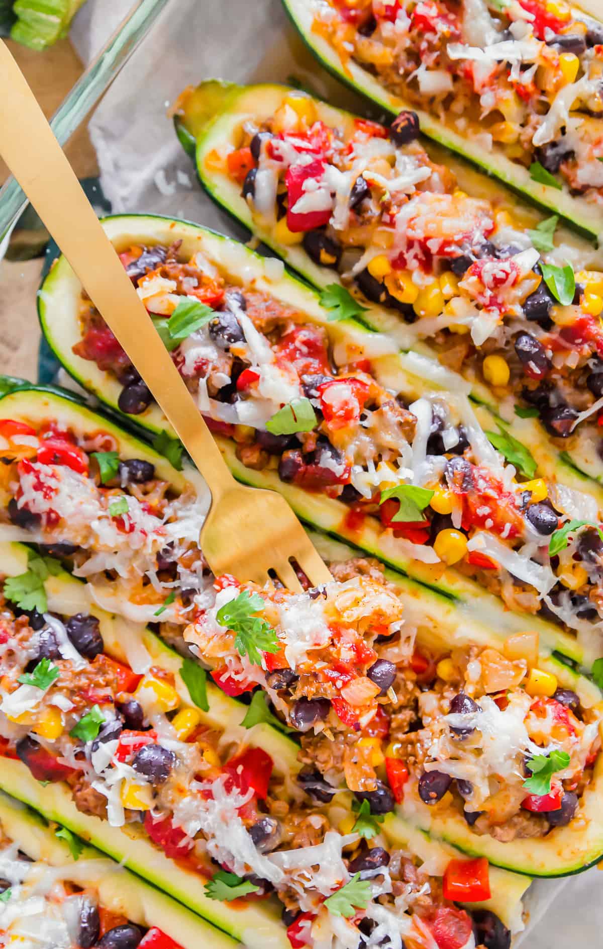 fork digging into zucchini boat