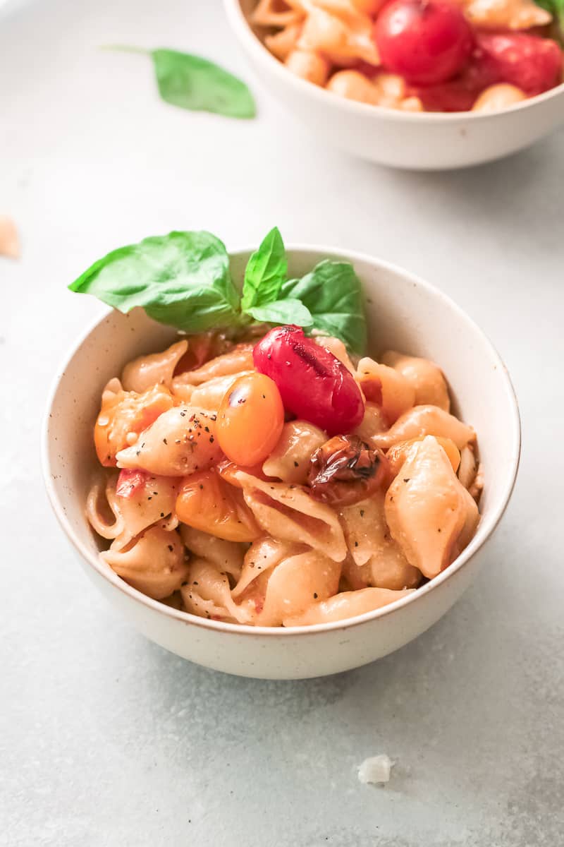 bowl of parmesan pasta with fresh basil