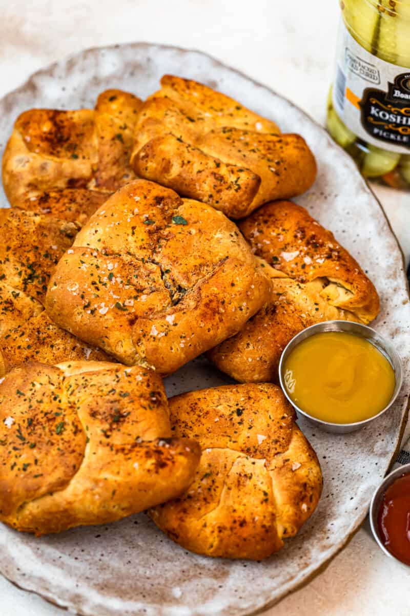 cheeseburger hand pies on platter with mustard and ketchup