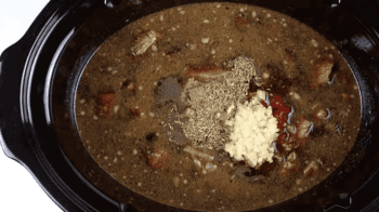 stew meat, broth, and seasonings in a crockpot.