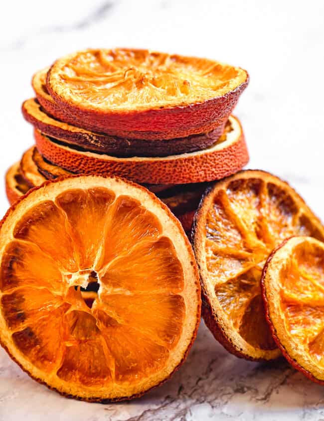 up close stacked dried orange slices on marble