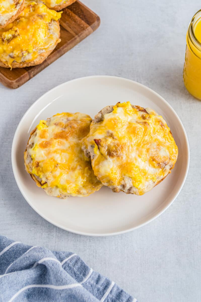 two english muffin breakfast pizzas on white plate