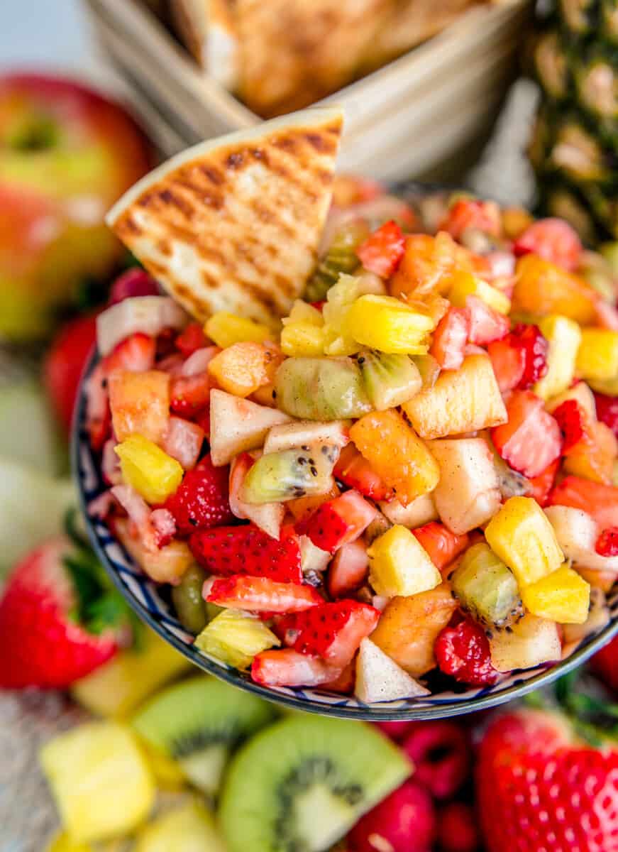 cinnamon chip dipping into fruit salsa