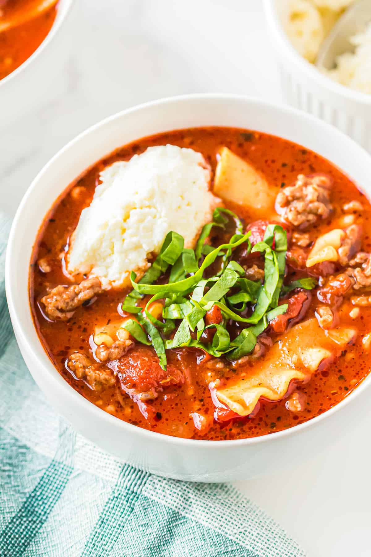 lasagna soup garnished with ricotta and basil