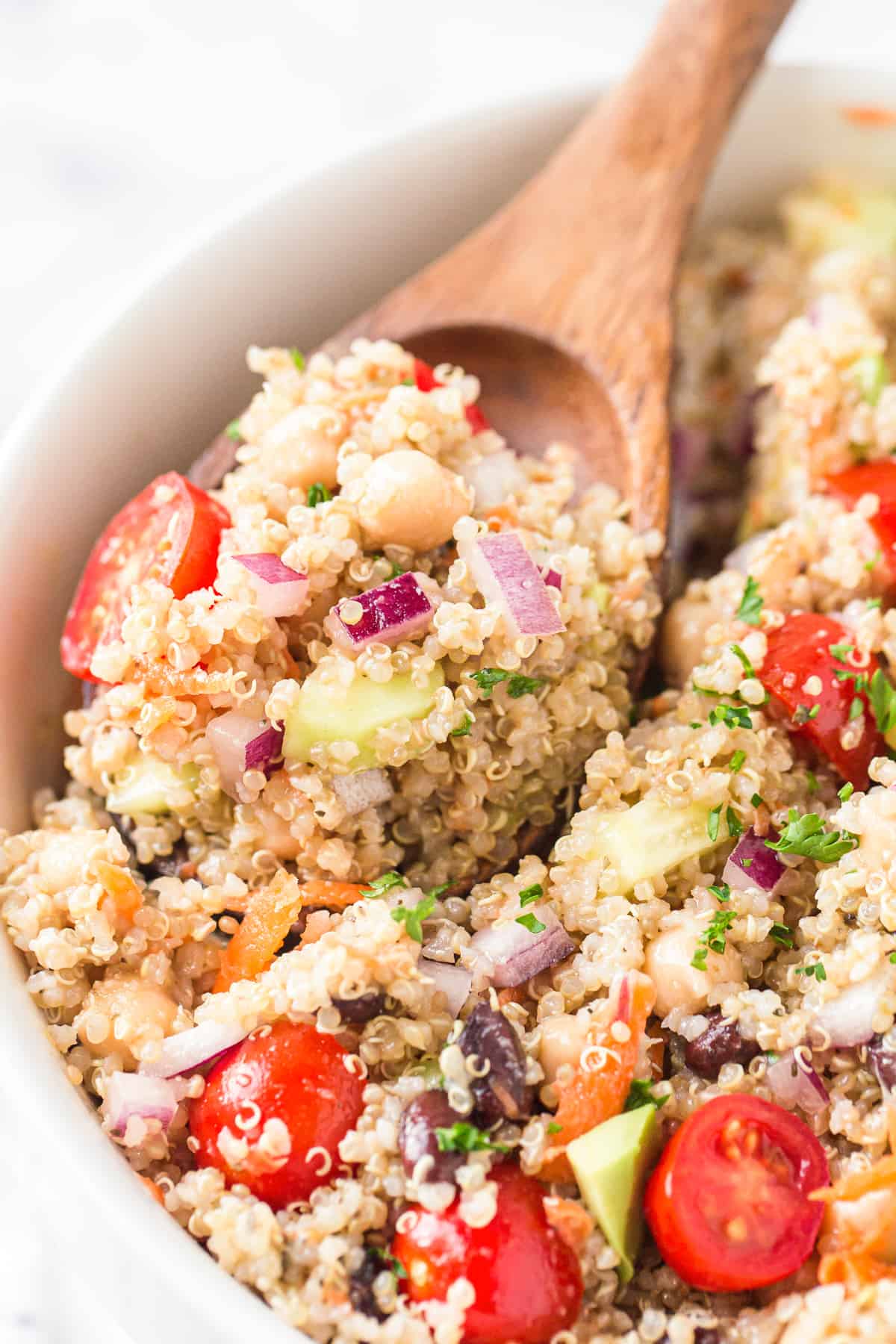 wooden spoon in quinoa salad