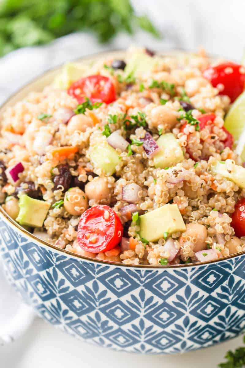 blue bowl filled with quinoa salad