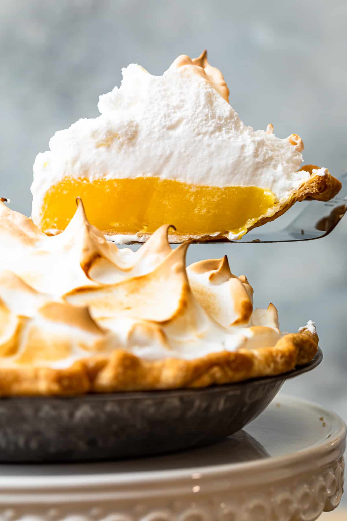 lifting up slice of lemon meringue pie