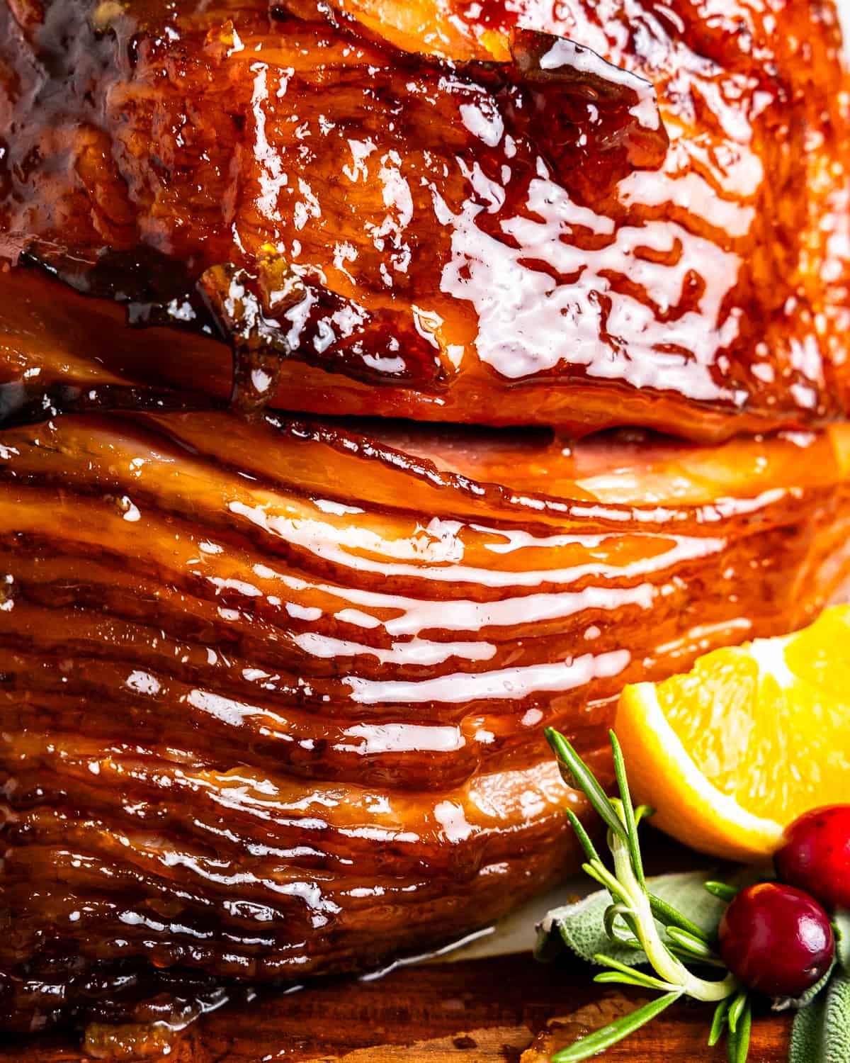 up close orange honey glazed ham showing slices