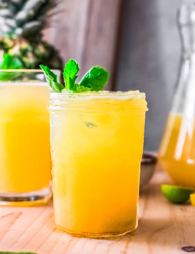 pineapple agua fresca in glass garnished with mint