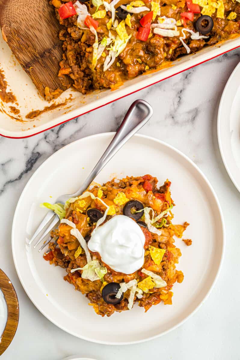 taco casserole on plate garnished with sour cream