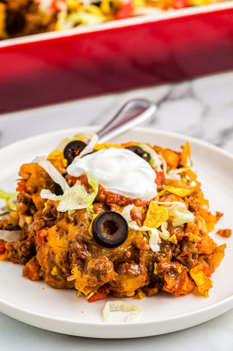 taco casserole on plate garnished with sour cream