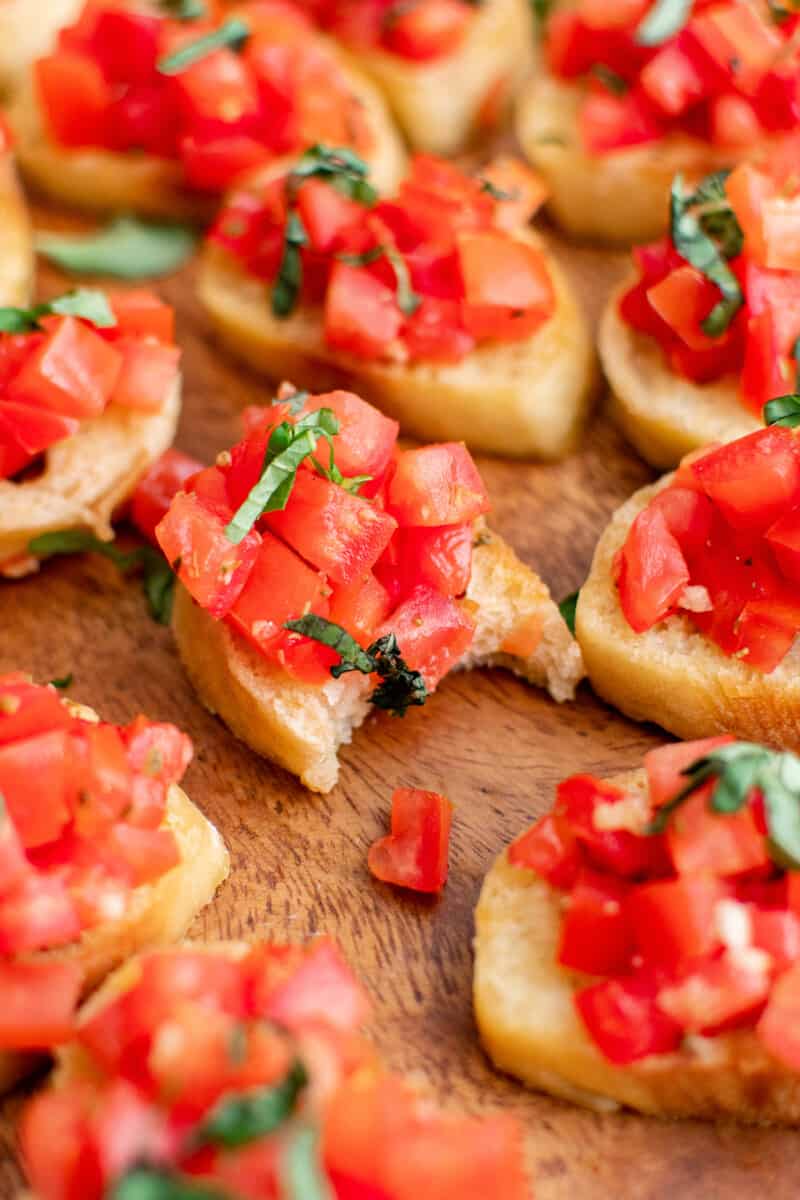 bite out of piece of tomato bruschetta