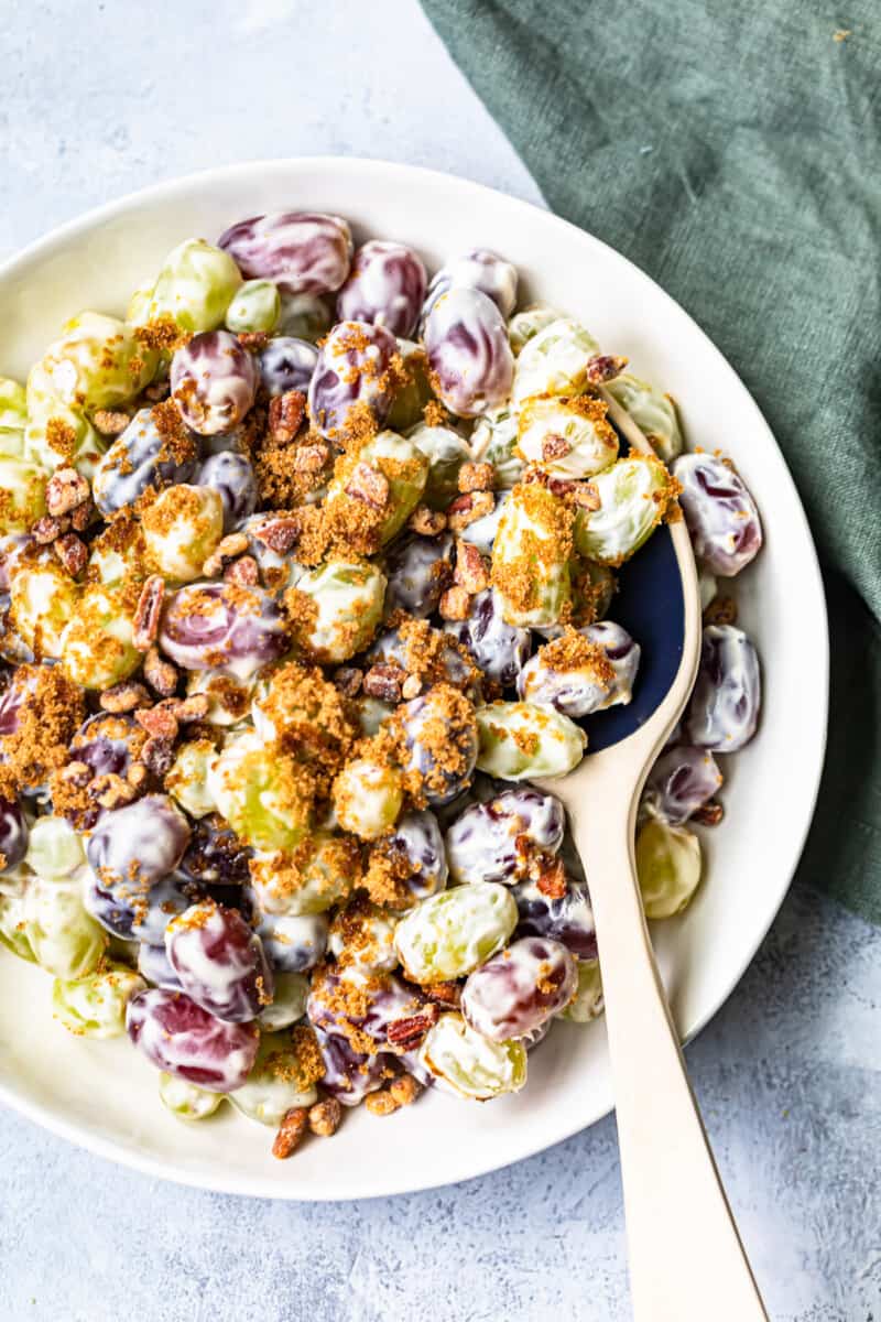 white bowl with grape salad and ceramic spoon