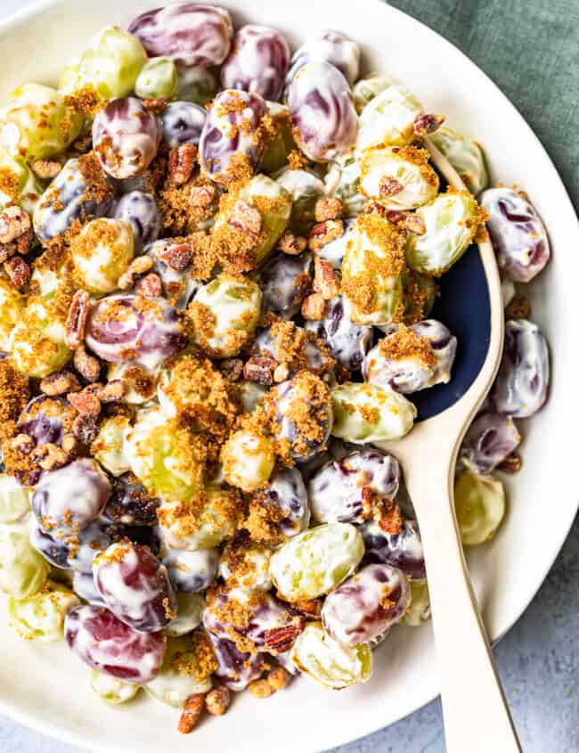 white bowl with grape salad and ceramic spoon