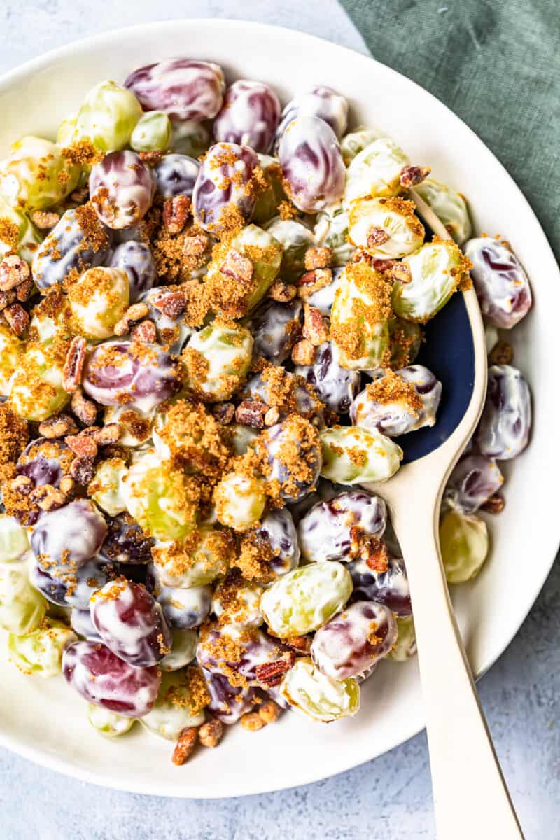 white bowl with grape salad and ceramic spoon