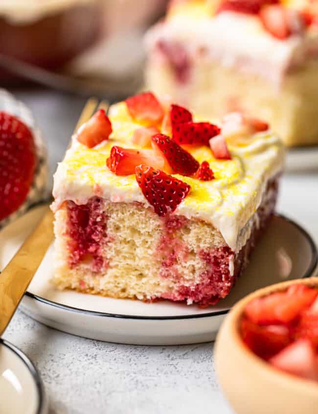 slice of strawberry lemonade poke cake