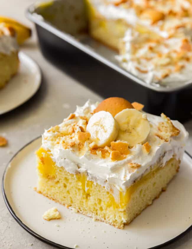 slice of banana pudding poke cake with vanilla wafers