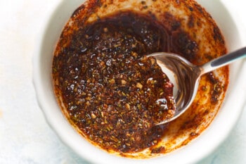 seasoning blend in a white bowl with a spoon.