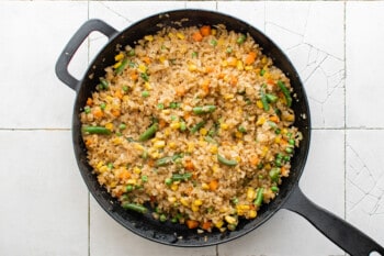 cauliflower fried rice in a cast iron pan.